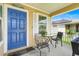 Charming front porch with blue door, seating area, and decorative accents, perfect for relaxing at 4649 College Dr, Orlando, FL 32811