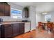 Well-lit kitchen featuring wood cabinets, a white dishwasher, and a view into the dining area at 4649 College Dr, Orlando, FL 32811