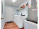 Convenient laundry room with washer, dryer, and storage shelves at 4649 College Dr, Orlando, FL 32811