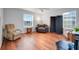 Relaxing living room with ample seating, hardwood floors, and natural light from the windows at 4649 College Dr, Orlando, FL 32811