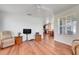 Cozy living room with hardwood floors, comfortable seating, and a view into the dining area at 4649 College Dr, Orlando, FL 32811
