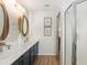 This renovated bathroom features double sinks, sleek countertops, and a tiled backsplash at 467 Weston Manor Dr, The Villages, FL 32162