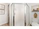 Bathroom featuring updated shower with glass door and neutral tile at 467 Weston Manor Dr, The Villages, FL 32162
