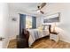 Cozy bedroom with natural light, wood-look floors, a ceiling fan, and stylish furnishings, perfect for relaxation at 467 Weston Manor Dr, The Villages, FL 32162