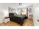 The relaxing bedroom has hardwood-style floors and large windows at 467 Weston Manor Dr, The Villages, FL 32162