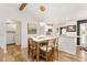 Open dining area with modern light fixture, stylish decor and beautiful wood flooring at 467 Weston Manor Dr, The Villages, FL 32162