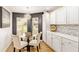 Charming dining area with a round glass table and a bright, stylish chandelier at 467 Weston Manor Dr, The Villages, FL 32162