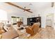 Bright living room with vaulted ceiling, wood beams, and cozy leather furniture at 467 Weston Manor Dr, The Villages, FL 32162