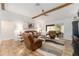 Comfortable living room featuring stylish furniture, vaulted ceiling and wood beam accents at 467 Weston Manor Dr, The Villages, FL 32162