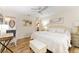This main bedroom features wood-look flooring, a ceiling fan, and calming decor at 467 Weston Manor Dr, The Villages, FL 32162
