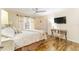 This light and airy main bedroom has beautiful floors and a ceiling fan at 467 Weston Manor Dr, The Villages, FL 32162