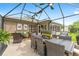 Outdoor patio offers ample seating, a dining area, and scenic views of the landscaped backyard, perfect for entertaining at 467 Weston Manor Dr, The Villages, FL 32162
