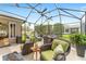 Spacious screened-in patio provides an ideal outdoor living space with comfortable seating and a dining area at 467 Weston Manor Dr, The Villages, FL 32162