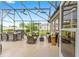 Screened patio offers ample seating, a dining area, and seamless indoor/outdoor living, ideal for entertaining guests at 467 Weston Manor Dr, The Villages, FL 32162
