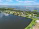 Scenic aerial view of lakeside homes, reflecting the sky in the tranquil water at 4835 Calasans Ave, St Cloud, FL 34771