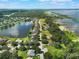 Community aerial highlighting lake and waterfront homes, showcasing pools and landscaping at 4835 Calasans Ave, St Cloud, FL 34771