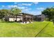 Spacious backyard with a pergola, patio seating area, and a screened-in pool at 4835 Calasans Ave, St Cloud, FL 34771