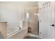 Bright bathroom features a garden tub, glass shower, and white tile at 4835 Calasans Ave, St Cloud, FL 34771