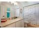 Well-lit bathroom features granite countertops and a decorative bird-themed shower curtain at 4835 Calasans Ave, St Cloud, FL 34771