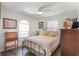 Cozy bedroom with wood floors, a ceiling fan, and abundant natural light at 4835 Calasans Ave, St Cloud, FL 34771