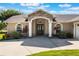 Inviting single-story home entrance with stone accents, arched entry, and manicured landscaping at 4835 Calasans Ave, St Cloud, FL 34771