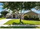 Single-story home features a well-manicured lawn and lush landscaping in a quiet residential neighborhood at 4835 Calasans Ave, St Cloud, FL 34771