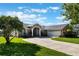 Charming single-story home with a well-manicured lawn, inviting entrance, and a spacious three-car garage at 4835 Calasans Ave, St Cloud, FL 34771