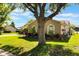 Single-story home features a well-manicured lawn, mature trees, and lush landscaping at 4835 Calasans Ave, St Cloud, FL 34771