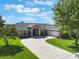 Charming single-story home with a well-manicured lawn, inviting entrance, and a spacious three-car garage at 4835 Calasans Ave, St Cloud, FL 34771