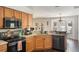 Bright kitchen with stainless steel appliances, granite counters, and open layout to dining area at 4835 Calasans Ave, St Cloud, FL 34771