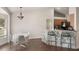 Eat-in kitchen featuring stone breakfast bar, modern lighting, and views of the backyard at 4835 Calasans Ave, St Cloud, FL 34771