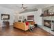 Elegant living room features a stone fireplace, hardwood floors, and an open floor plan at 4835 Calasans Ave, St Cloud, FL 34771