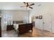 Light-filled main bedroom with ceiling fan, en-suite access, and tile floors at 4835 Calasans Ave, St Cloud, FL 34771