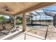 Inviting screened-in pool area overlooking the lake, perfect for outdoor dining and relaxation at 4835 Calasans Ave, St Cloud, FL 34771