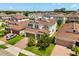 This front aerial view highlights the home's brick paved driveway and manicured lawn at 4869 Grassendale Ter, Sanford, FL 32771