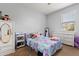 Cozy bedroom with patterned bedding, a large window, white dresser and white armoire at 4869 Grassendale Ter, Sanford, FL 32771