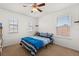Cozy bedroom with a ceiling fan, carpeting, two windows, and a blue and white striped bedspread at 4869 Grassendale Ter, Sanford, FL 32771