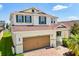Charming home with a two-car garage, brick driveway, manicured lawn, and a welcoming front porch at 4869 Grassendale Ter, Sanford, FL 32771