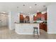 Bright kitchen with stainless steel appliances, a breakfast bar, tile floors, and plenty of cabinet space at 4869 Grassendale Ter, Sanford, FL 32771
