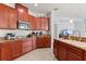 Modern kitchen featuring stainless steel appliances, granite countertops, and ample cabinet space for storage at 4869 Grassendale Ter, Sanford, FL 32771