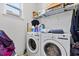 Bright laundry room features a modern washer and dryer set, storage shelf, and natural light at 4869 Grassendale Ter, Sanford, FL 32771