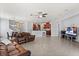 Open-concept living space with tile floors, a large leather sofa, and access to the kitchen at 4869 Grassendale Ter, Sanford, FL 32771
