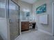 The bathroom features tile floors, a glass shower, and a vanity with stool at 4976 Sandpiper Dr, Oxford, FL 34484