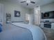 The bedroom includes carpet flooring, light walls, and a television at 4976 Sandpiper Dr, Oxford, FL 34484