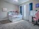 This bedroom has carpet flooring, light walls, and a ceiling fan at 4976 Sandpiper Dr, Oxford, FL 34484