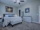 This bedroom has carpet flooring, neutral walls, and a ceiling fan at 4976 Sandpiper Dr, Oxford, FL 34484