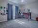 Bedroom with large window, ceiling fan, carpet and a loft bed with storage underneath at 4976 Sandpiper Dr, Oxford, FL 34484