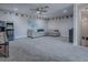 Large bonus room with carpet, sectional sofa, and Golden Tee arcade game at 4976 Sandpiper Dr, Oxford, FL 34484