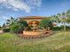 Picturesque community center boasts lush landscaping, palm trees and a beautiful water fountain feature at 4976 Sandpiper Dr, Oxford, FL 34484