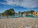 Beautiful community pool with rock features, pergolas, and landscaping at 4976 Sandpiper Dr, Oxford, FL 34484